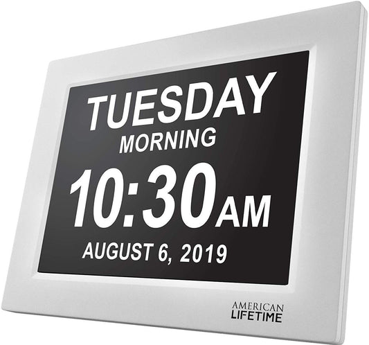 Silver and black clock displaying the date, time and day