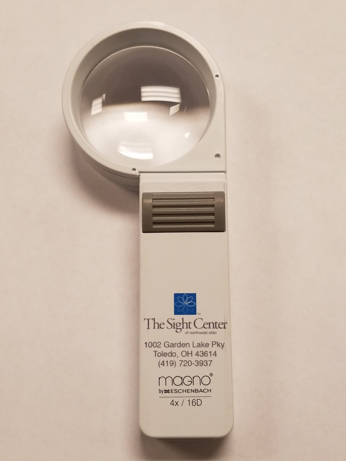 a 4x Hand Held Magnifier with the Sight Center Logo, address and phone number