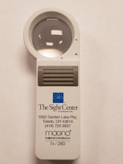 a 7x Hand Held Magnifier with the Sight Center Logo, address and phone number