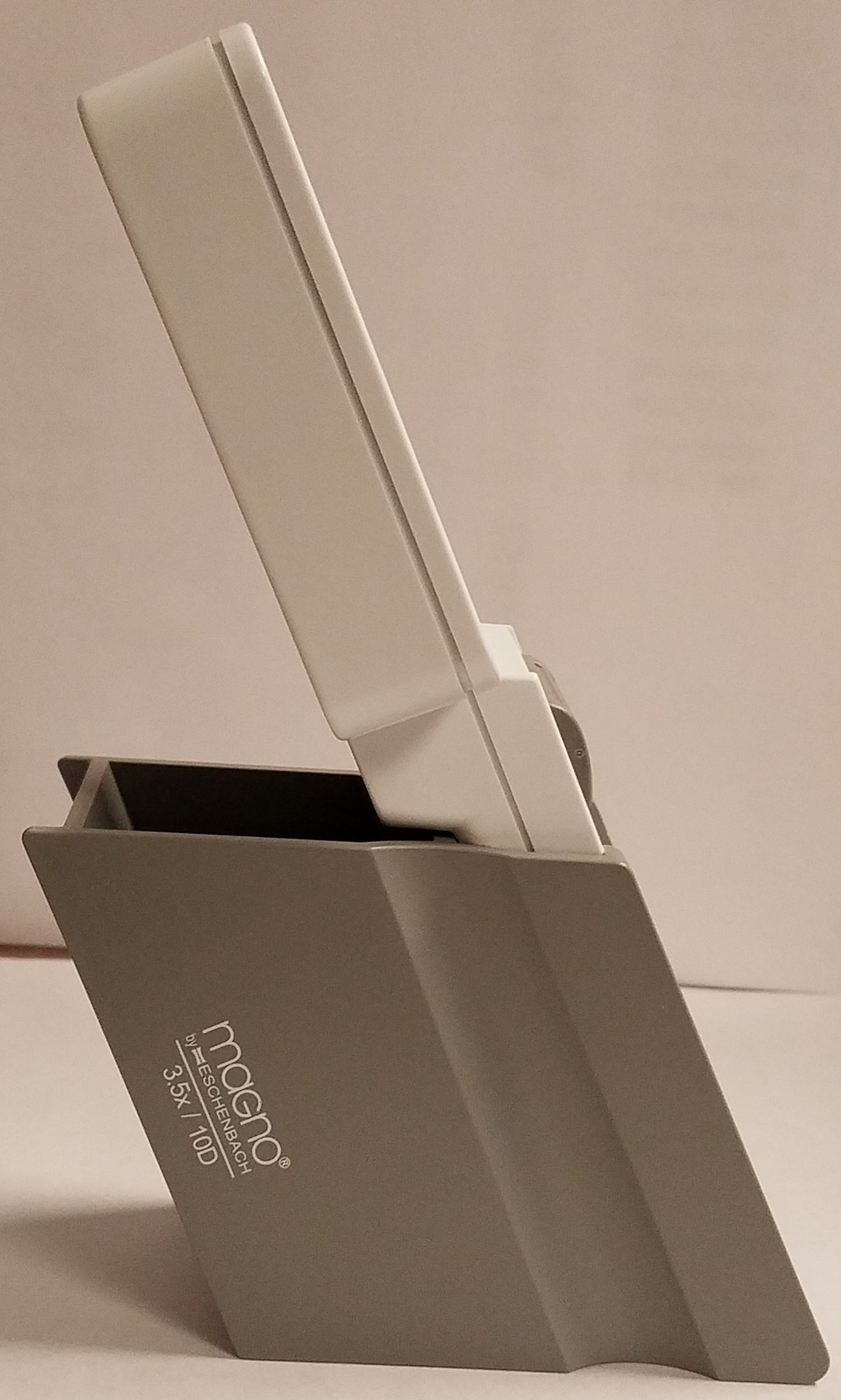 An Eschenbach stand holding a magnifier. Side view