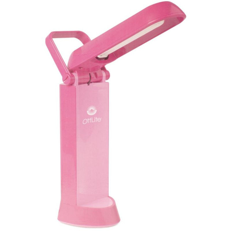 A pink lamp that has a handle and the light part flips up and shines light on the darkness