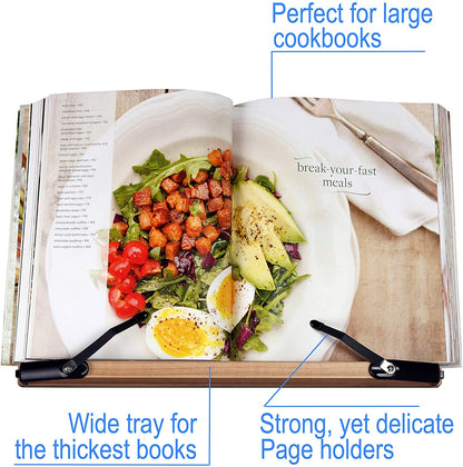 The slant board in use while someone is looking at a large cookbook